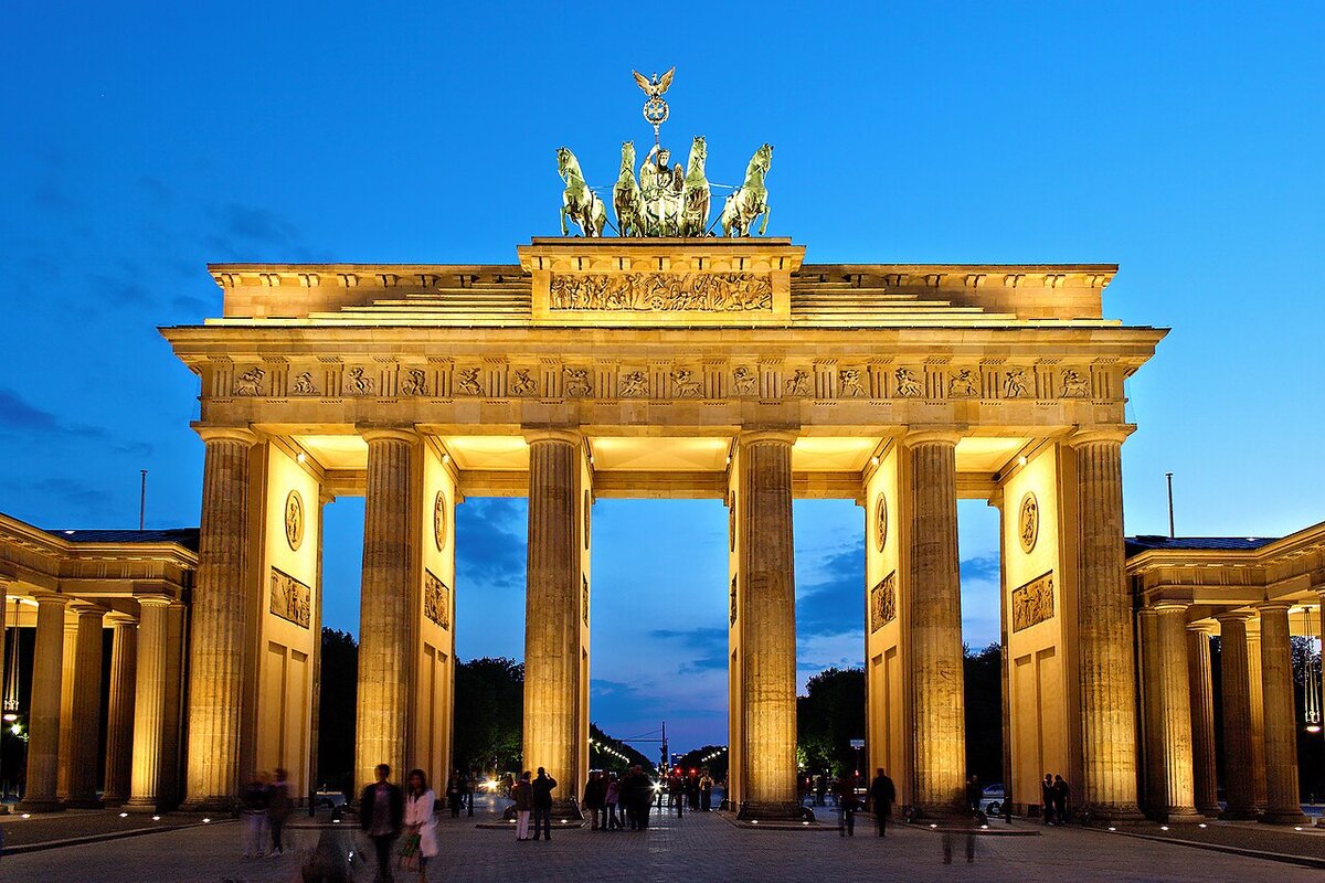 Brandenburg Gate illuminated at night, once divided by the Berlin Wall
