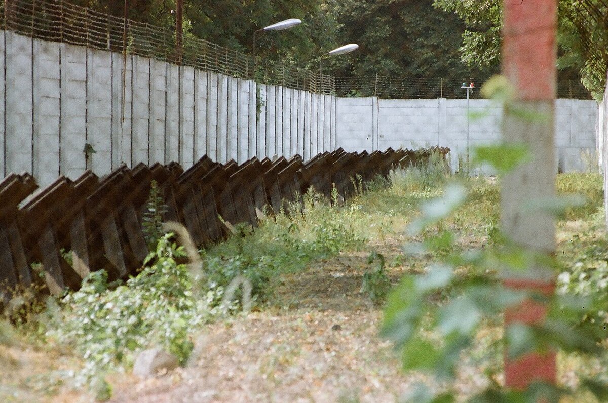 Border fence surrounding Steinstücken railway line, with tank traps